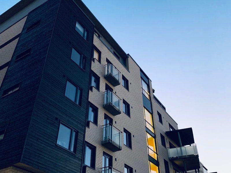 Modern multi-storey condominium building against a clear sky