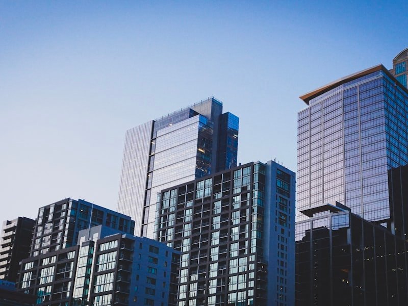 Glass condominium towers under a clear sky